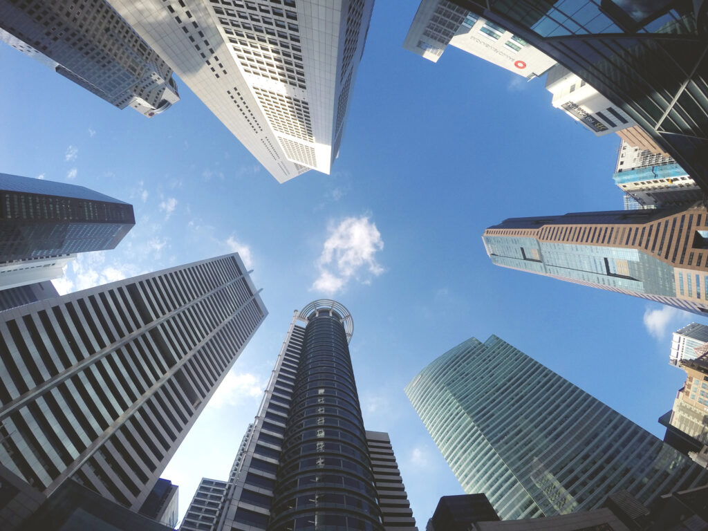 fisheye lens shot of towering skyscrapers as see from the ground